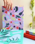 Close-up of Garden Sketchbook cover revealing abstract floral patterns in soft violet hues