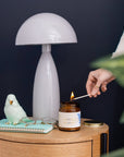 Northern Breeze Fragrance Set with amber glass diffuser and golden lid on wooden table, styled with mint green ceramic bird and gold-rimmed notebook