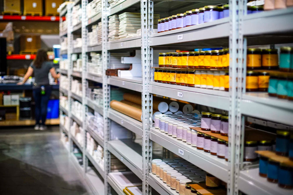 Baltic Club HQ warehouse shelves with candles and notebooks