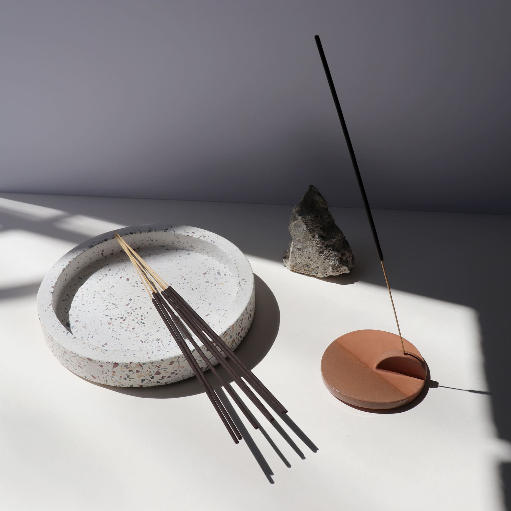 Eight incense sticks displayed near an incense holder