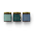 Boreal Collection candle gift set with three amber glass jars topped by ribbed golden lids