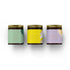 Candle Gift Set Rêverie Collection in dark glass jars with golden lids on white background