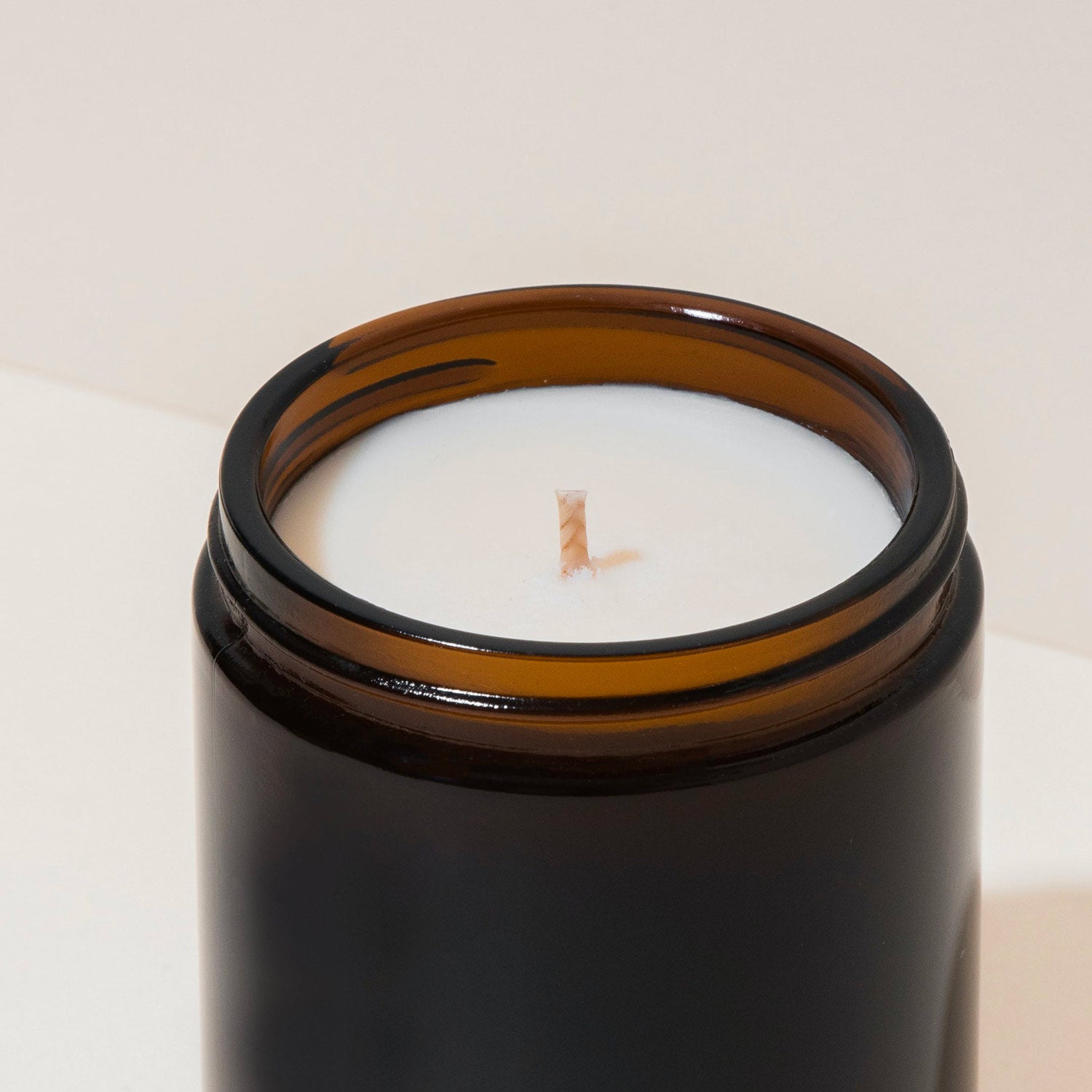 New soy wax candle in amber jar close view