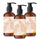 Three amber glass bottles of Bergamot and Neroli Petals hand soap with black pumps on a white background