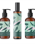Amber glass bottles of Baltic Club eucalyptus grapefruit lotion, spray, and soap with mint green labels on white background