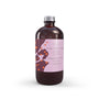 Ginger & Black Pepper reed diffuser refill in a sleek transparent bottle with amber liquid