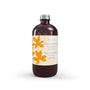 Recharge diffuseur à roseaux Bois de Santal Doré en bouteille verre ambré brillant avec bouchon argenté texturé et étiquette crème florale