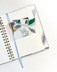 The pocket located at the back of the Blue Ash Cloth-covered Undated Planner from The Baltic Club