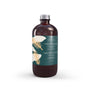 White Fir & Peach reed diffuser refill in a clear glass bottle with minimalist label, evoking fresh and fruity ambiance