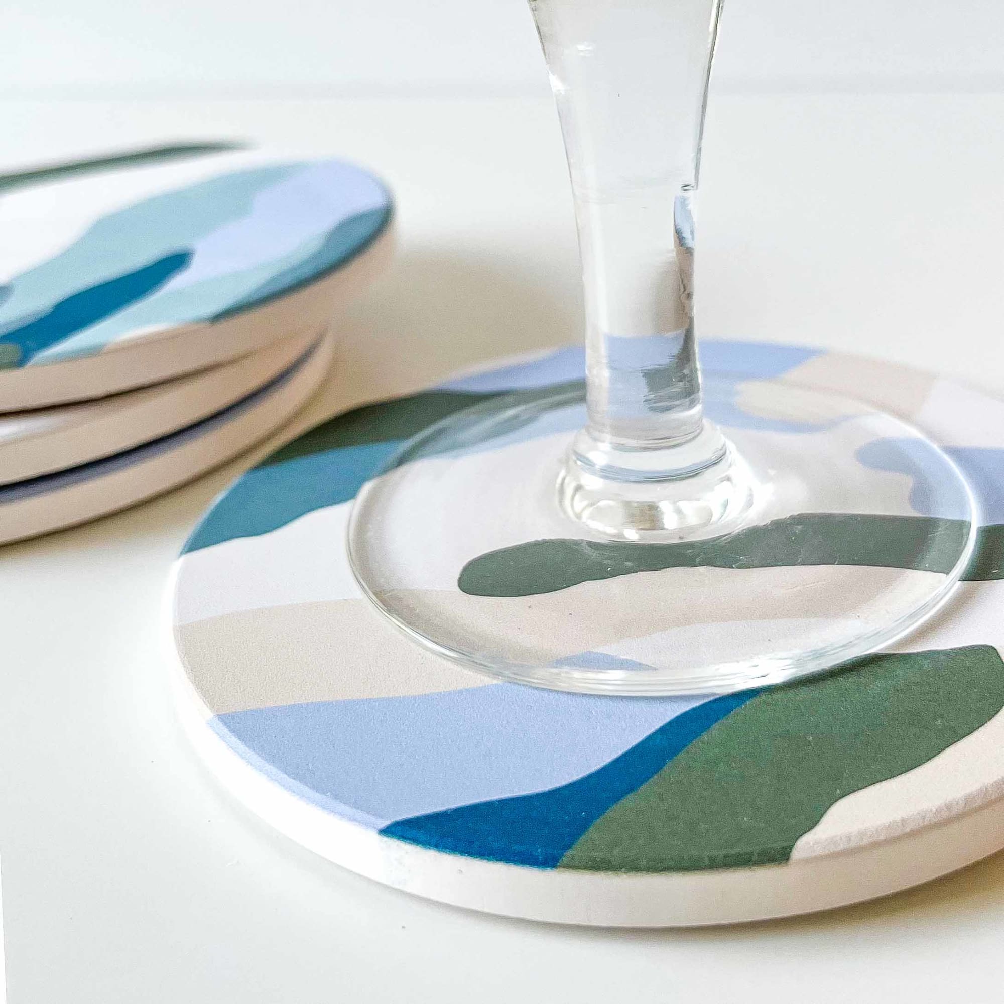 Closeup on the foot of a glass on a ceramic coaster designed by The Baltic Club